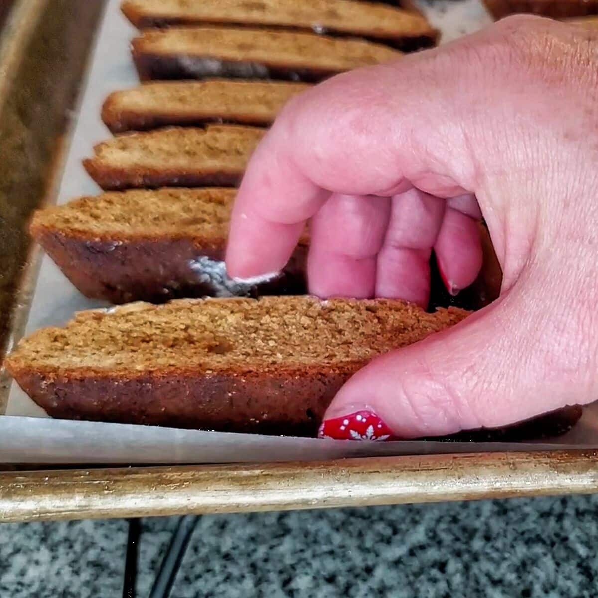 placing cut biscotti on prepared baking sheet for baking a second time.
