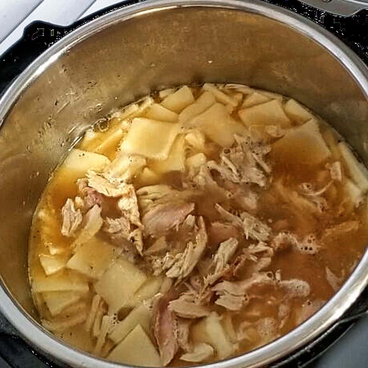 adding shredded chicken back into chicken stock.