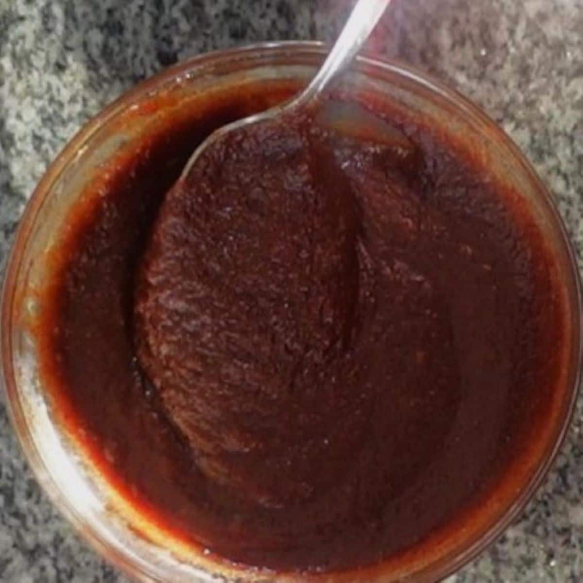 filling paste mixed together in small glass bowl with stainless steel spoon.