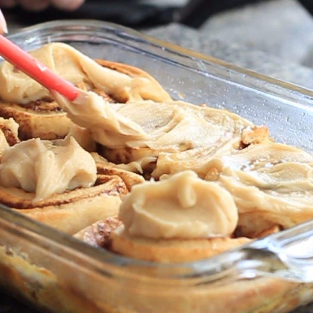 spreading frosting immediately on rolls as they come out of the oven.