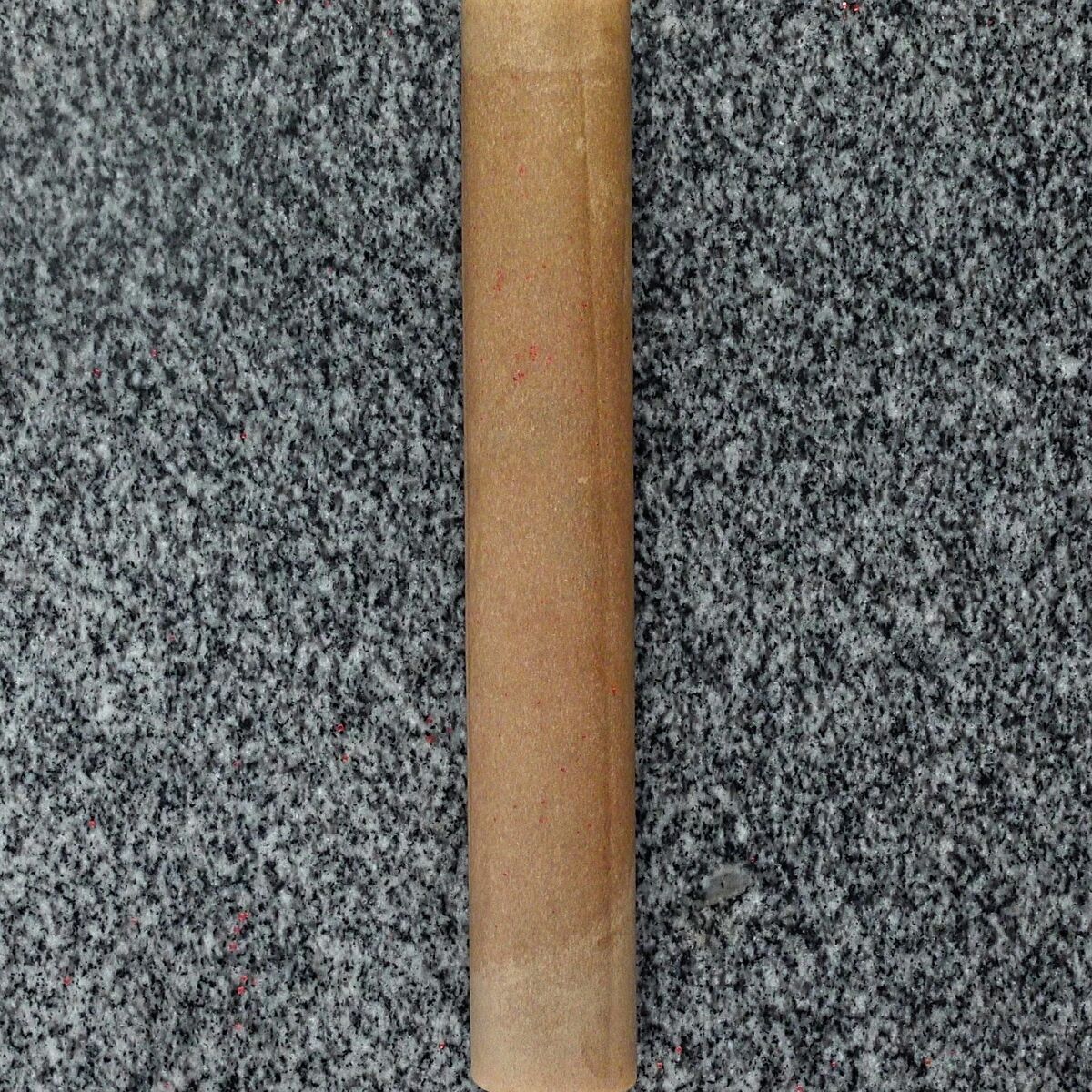 log of dough rolled up in parchment paper.