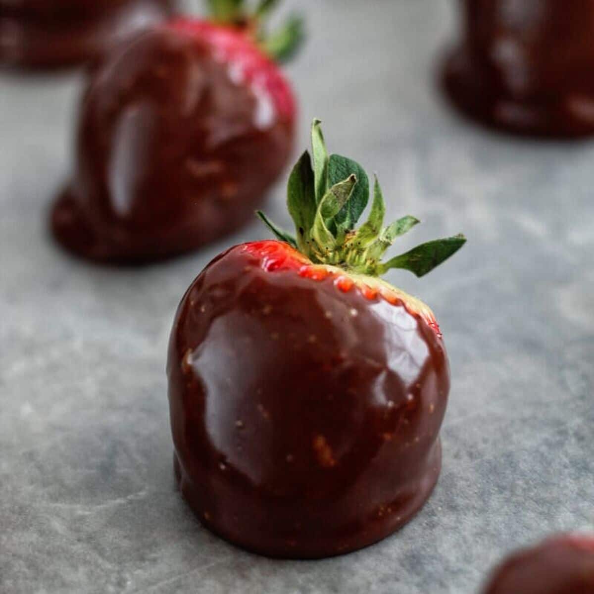 chocolate covered strawberries on waxed paper.