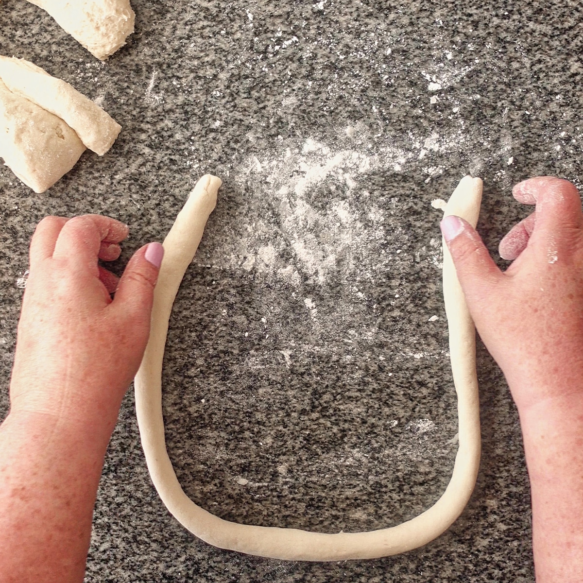 making a U shape with pretzel dough.