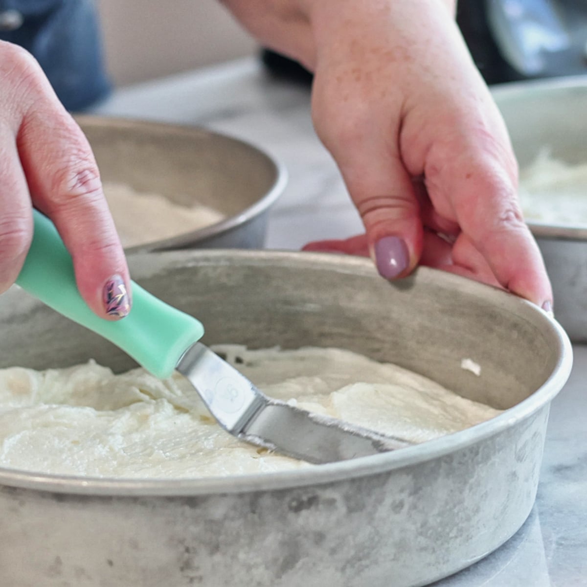 smoothing top of batter in cake pans.