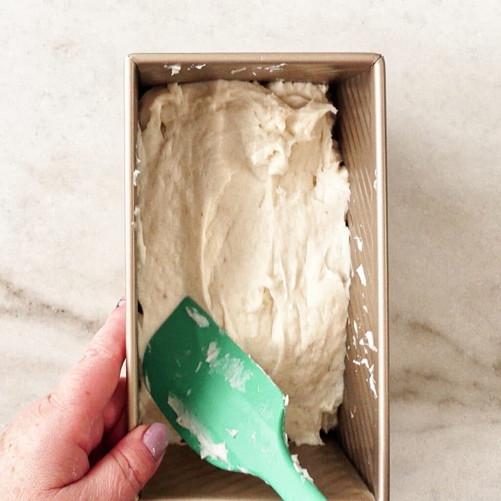 spreading dough into loaf pan.