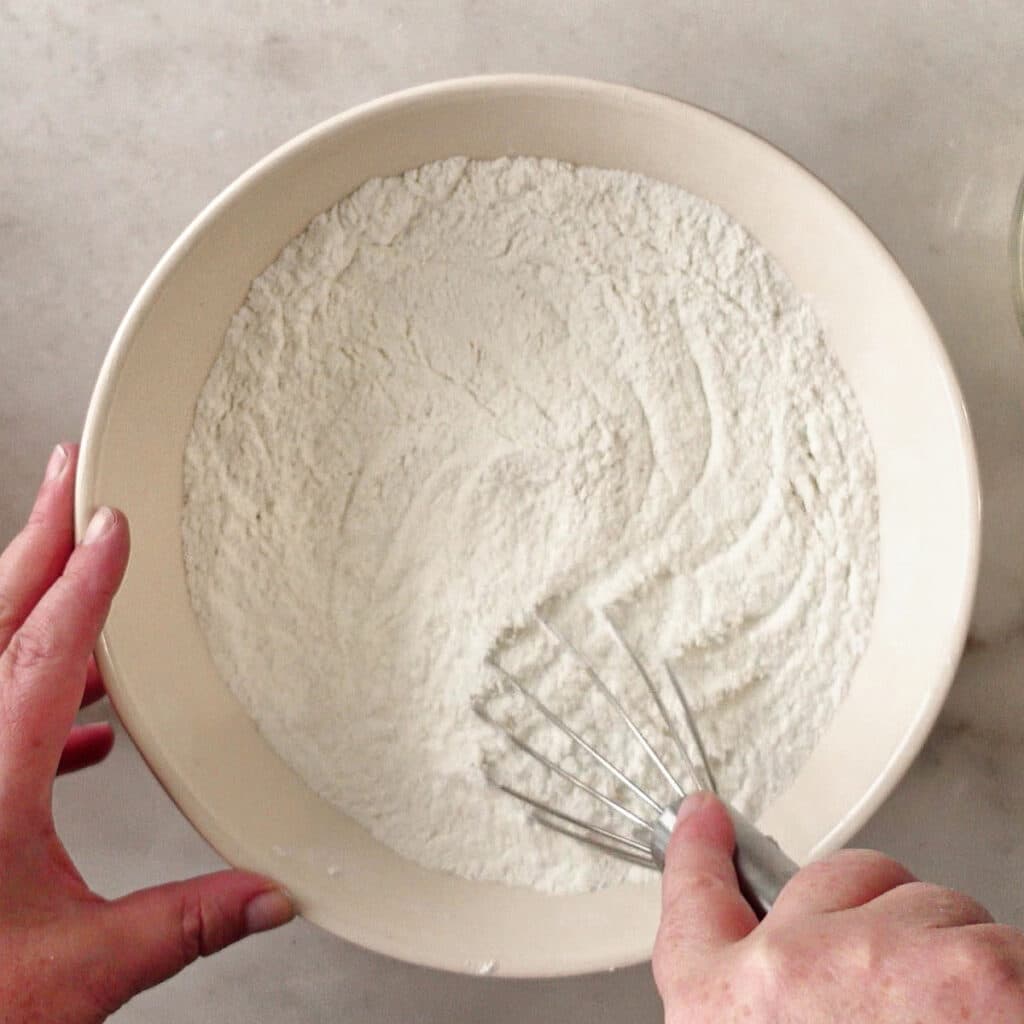 whisking dry ingredients in large bowl.
