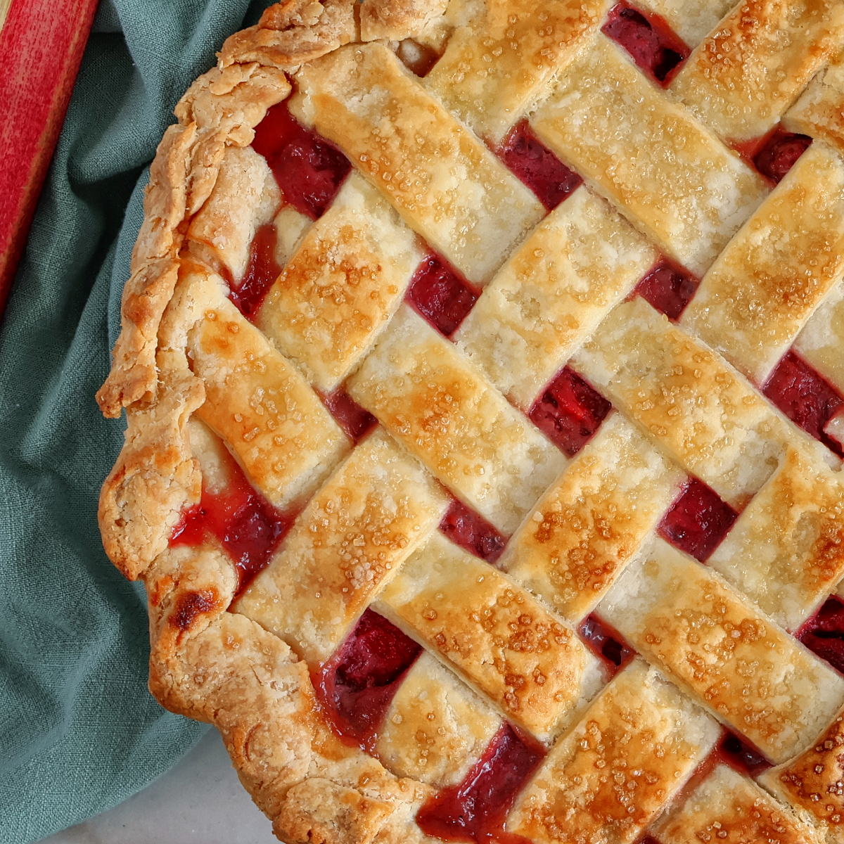 whole strawberry rhubarb pie with lattice top crust.