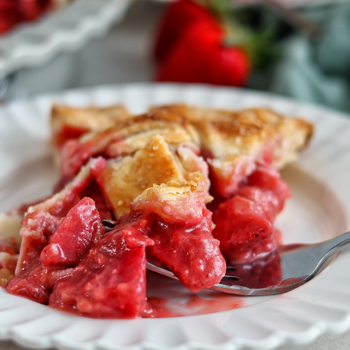 slice of pie on white plate with bite on fork.
