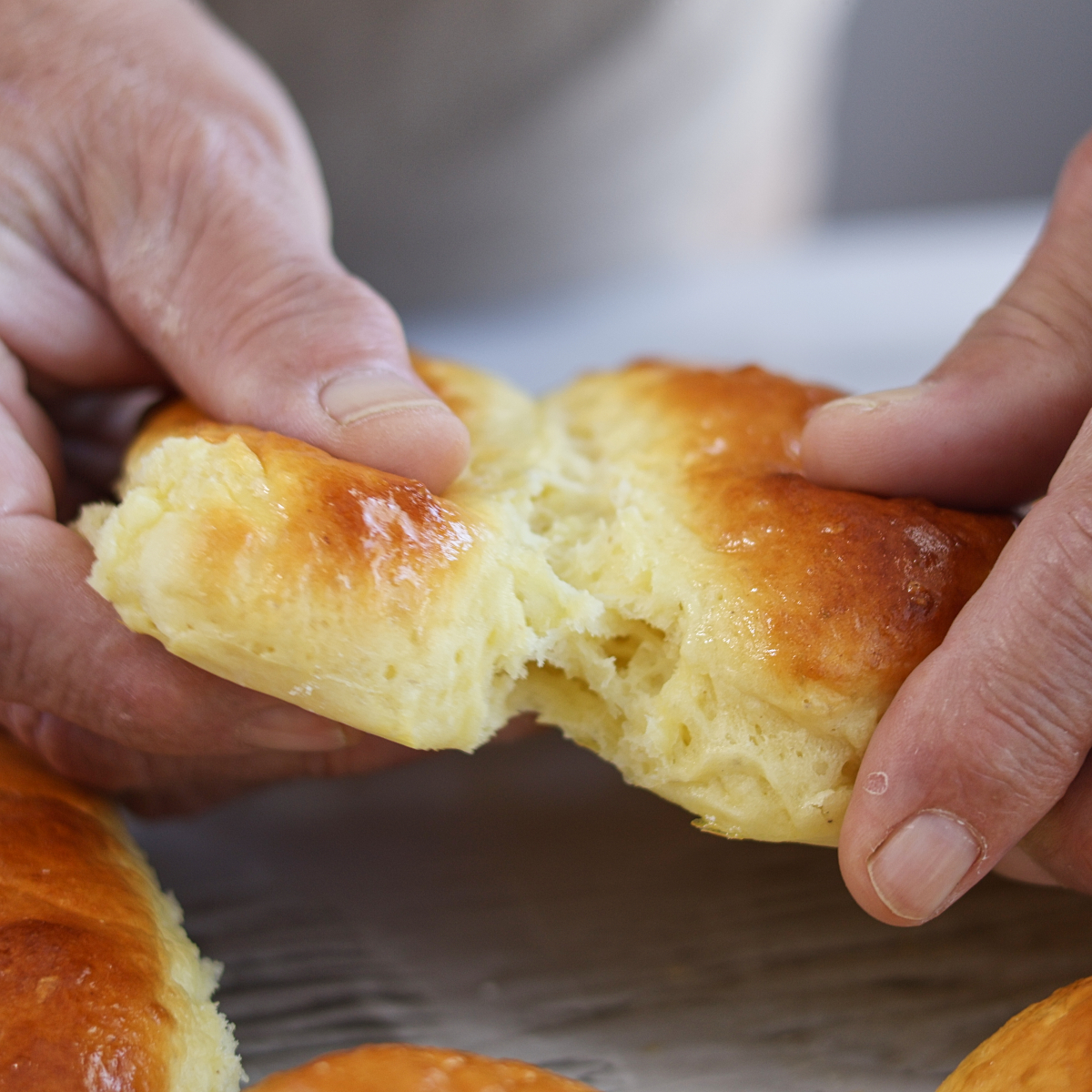 tearing apart two hot dog buns.