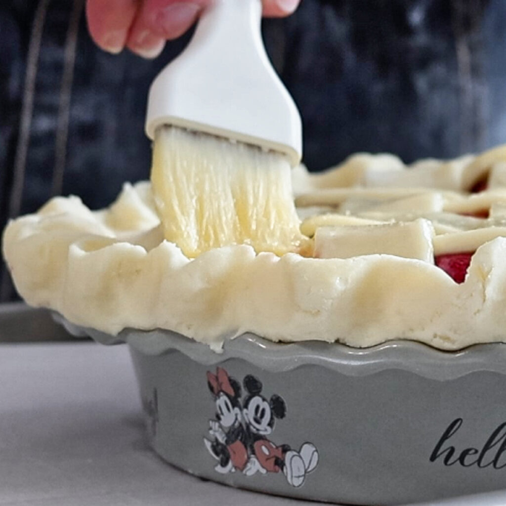brushing top of pie with egg wash.