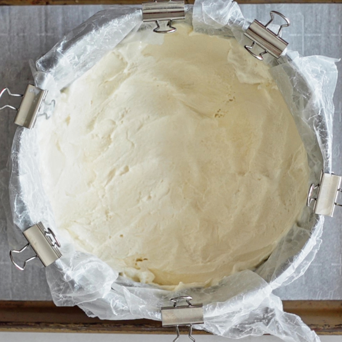 vanilla ice cream spread into bottom of lined cake ring.