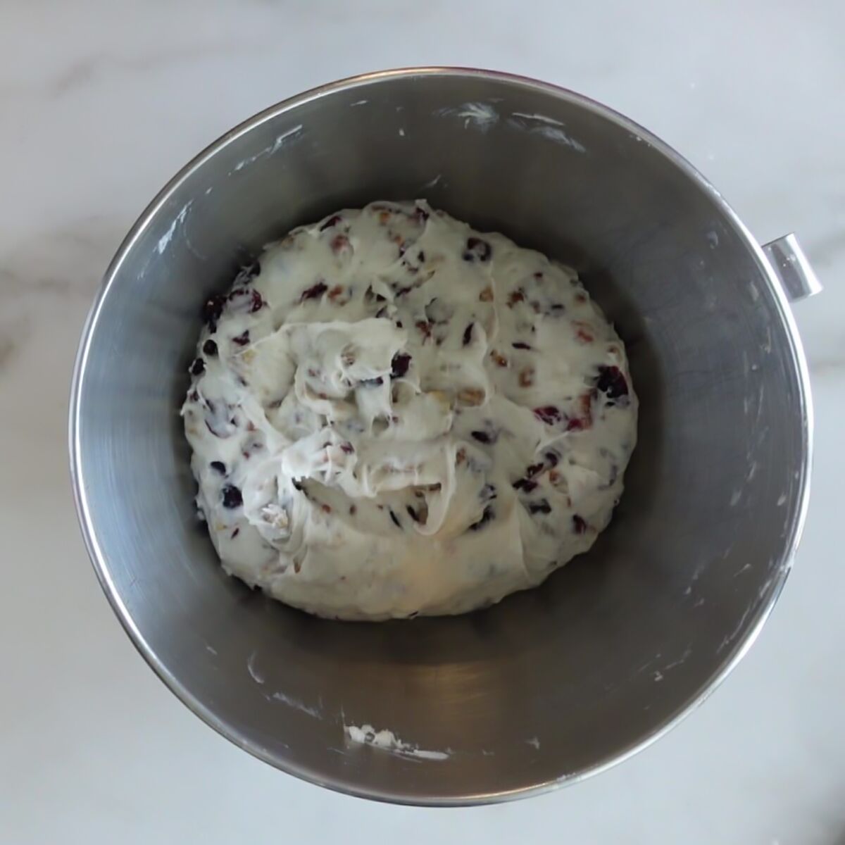 mixed together dough in stainless steel mixing bowl.