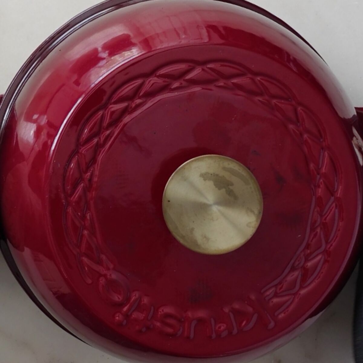 red lid placed on red bread baker.