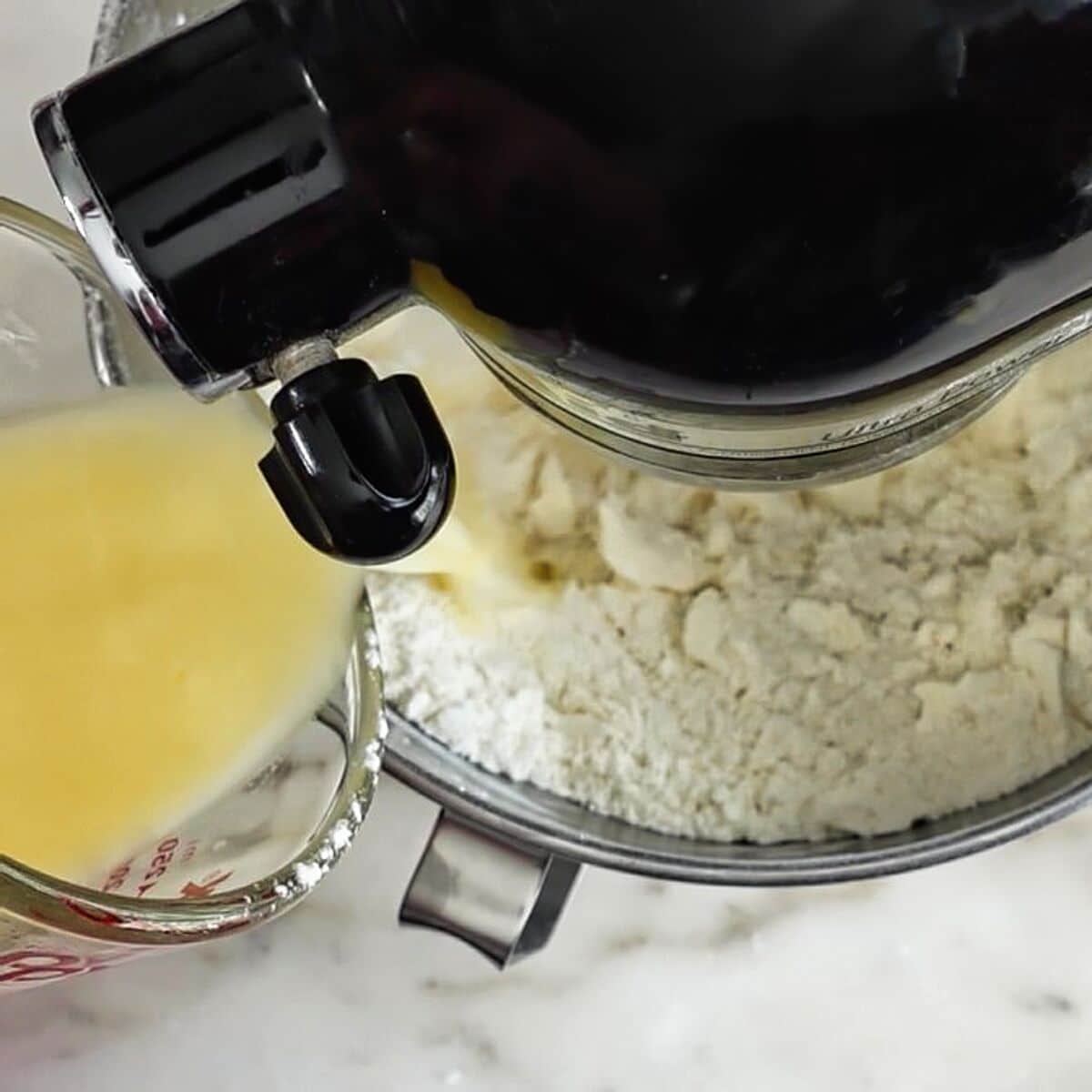 pouring egg/vinegar/water mixture into butter and flour mixture in stand mixer.