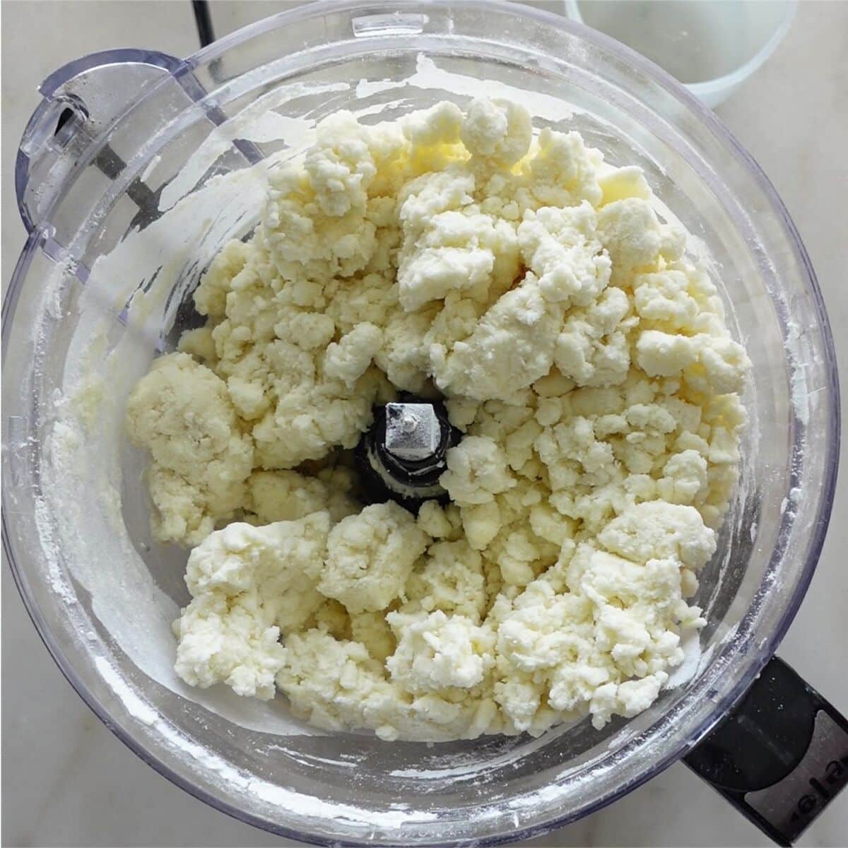 pie crust coming together in large chunks in food processor.