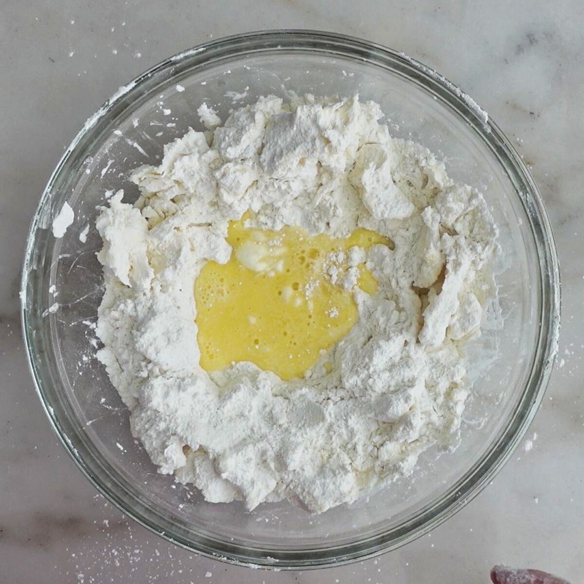 egg/water mixture poured into the center of the flour/butter mixture in large bowl.