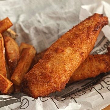fish and chips in basket lined with newspaper.