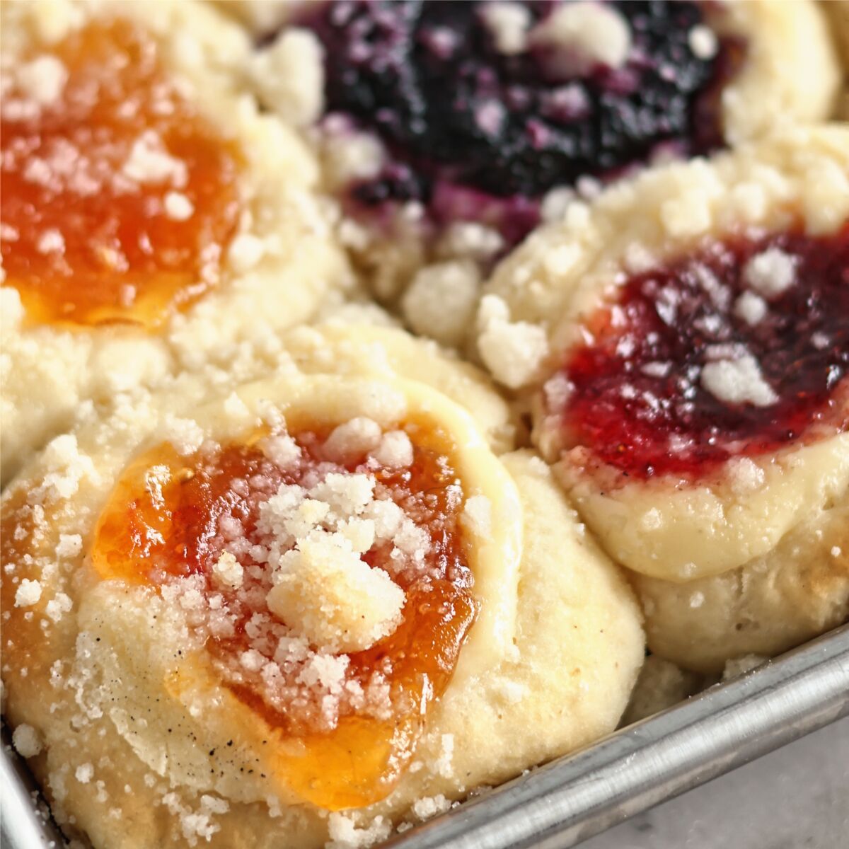 gluten free kolaches up close on stainless steel sheet pan.