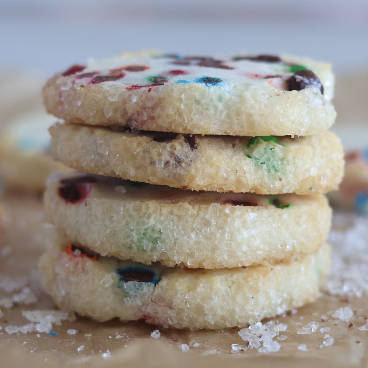 stack of 4 cookies on brown parchment paper.