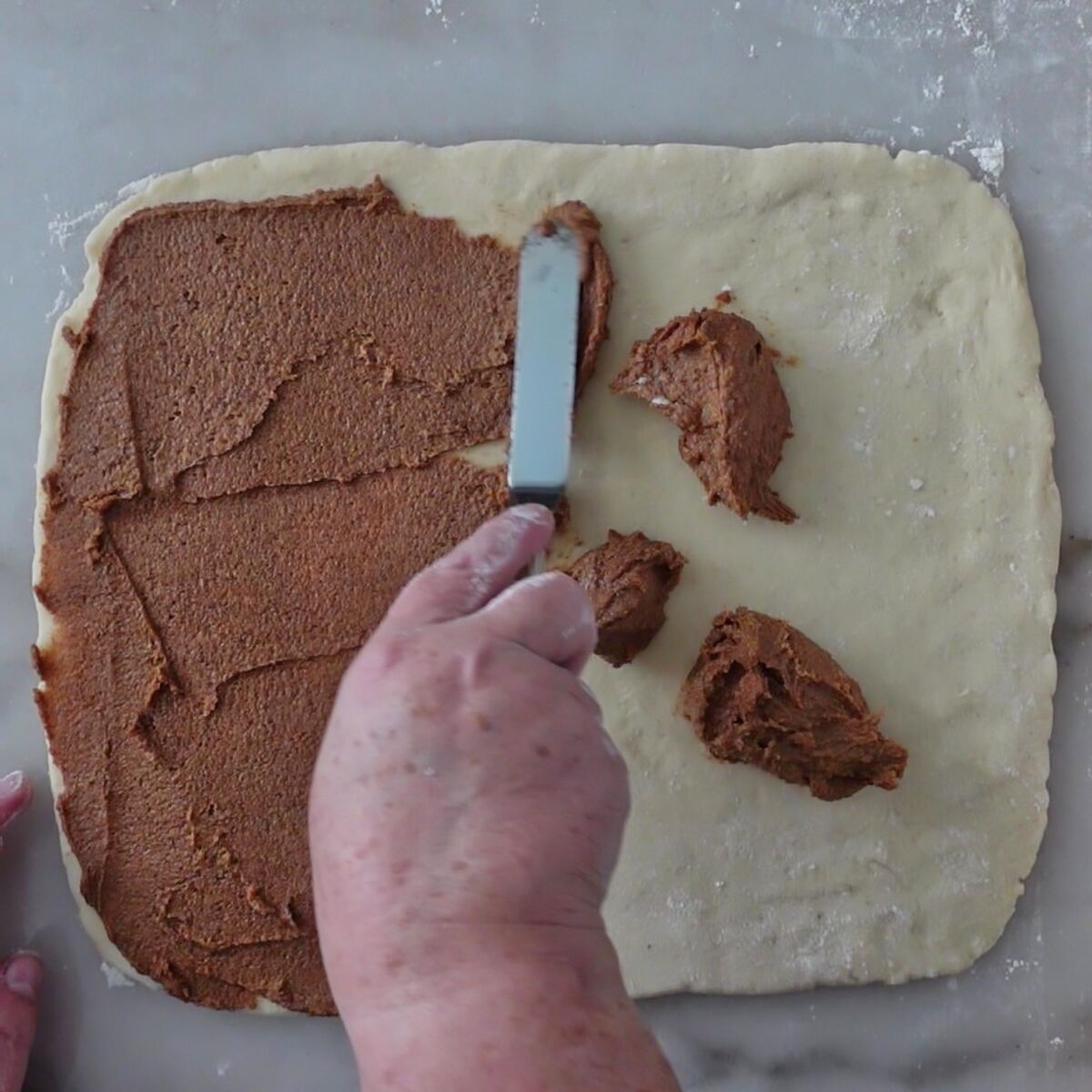 spreading filling over rectangle of dough.