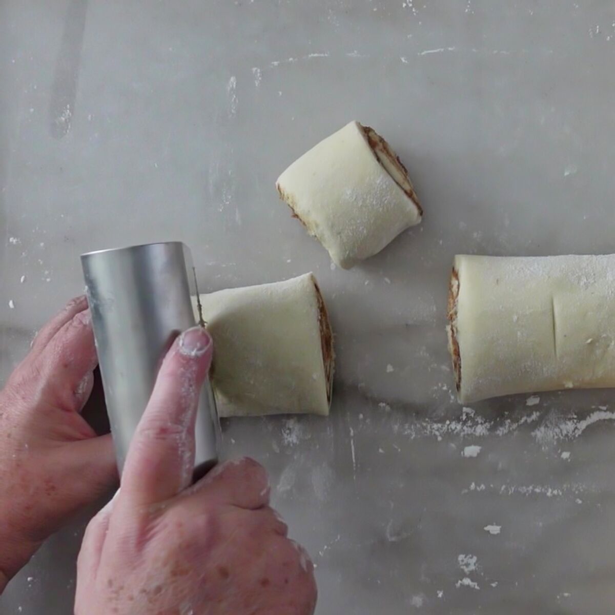 cutting log into individual rolls with bench scraper.