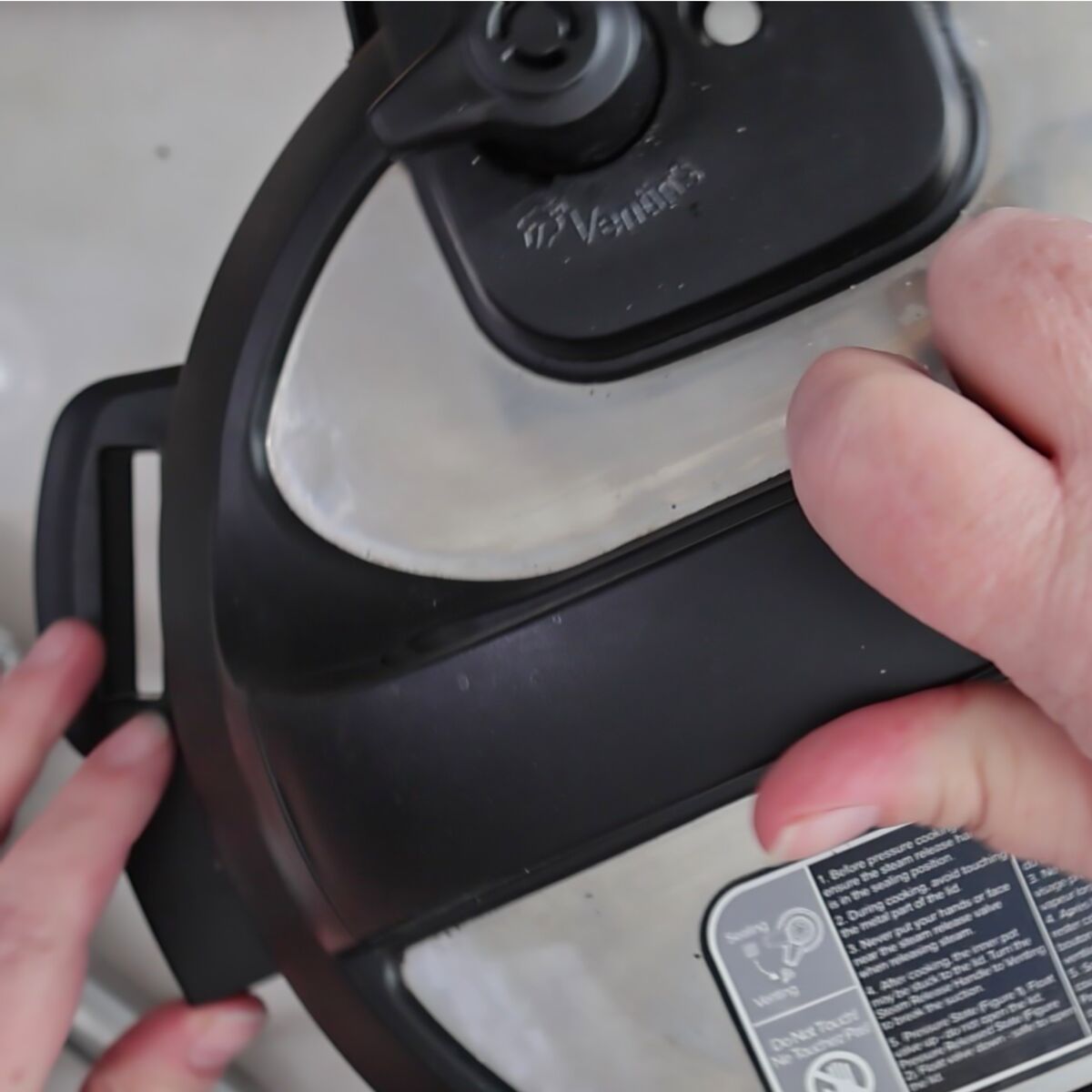 securing the lid on the instant pot.