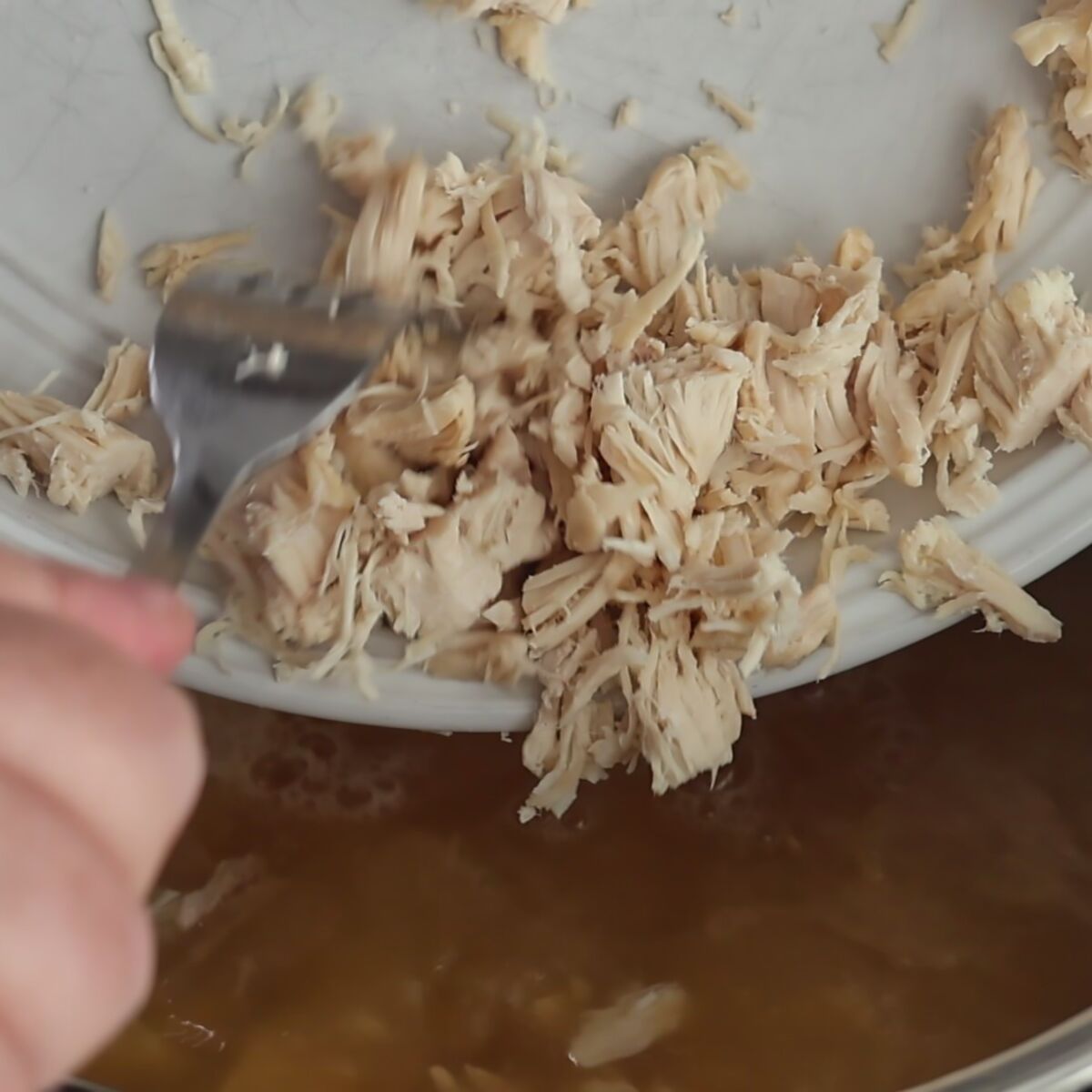adding shredded chicken to soup in instant pot.