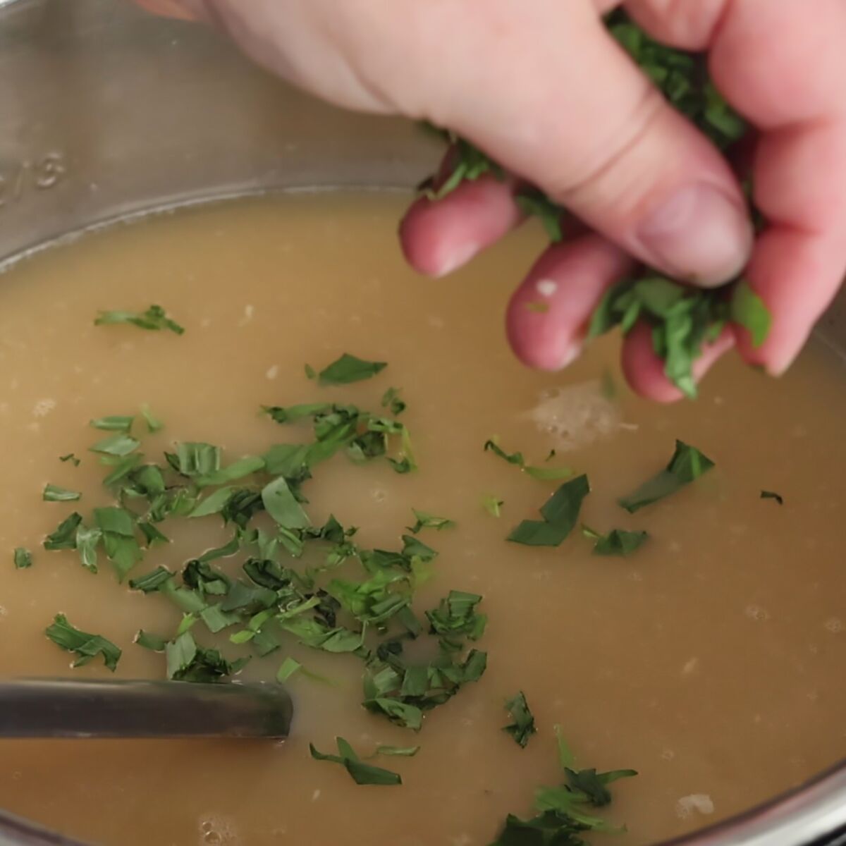 sprinkling chopped tarragon on top of soup.