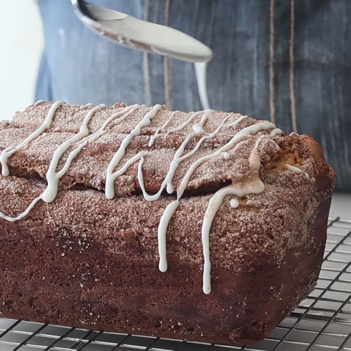 drizzling cinnamon bread with white icing.