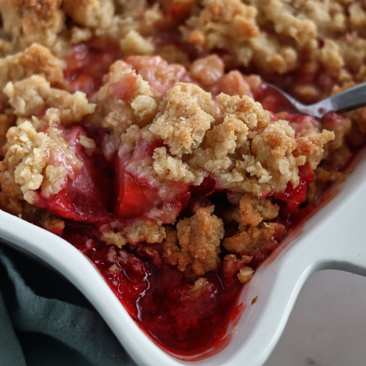getting up close with a large scoop of strawberry rhubarb crisp.