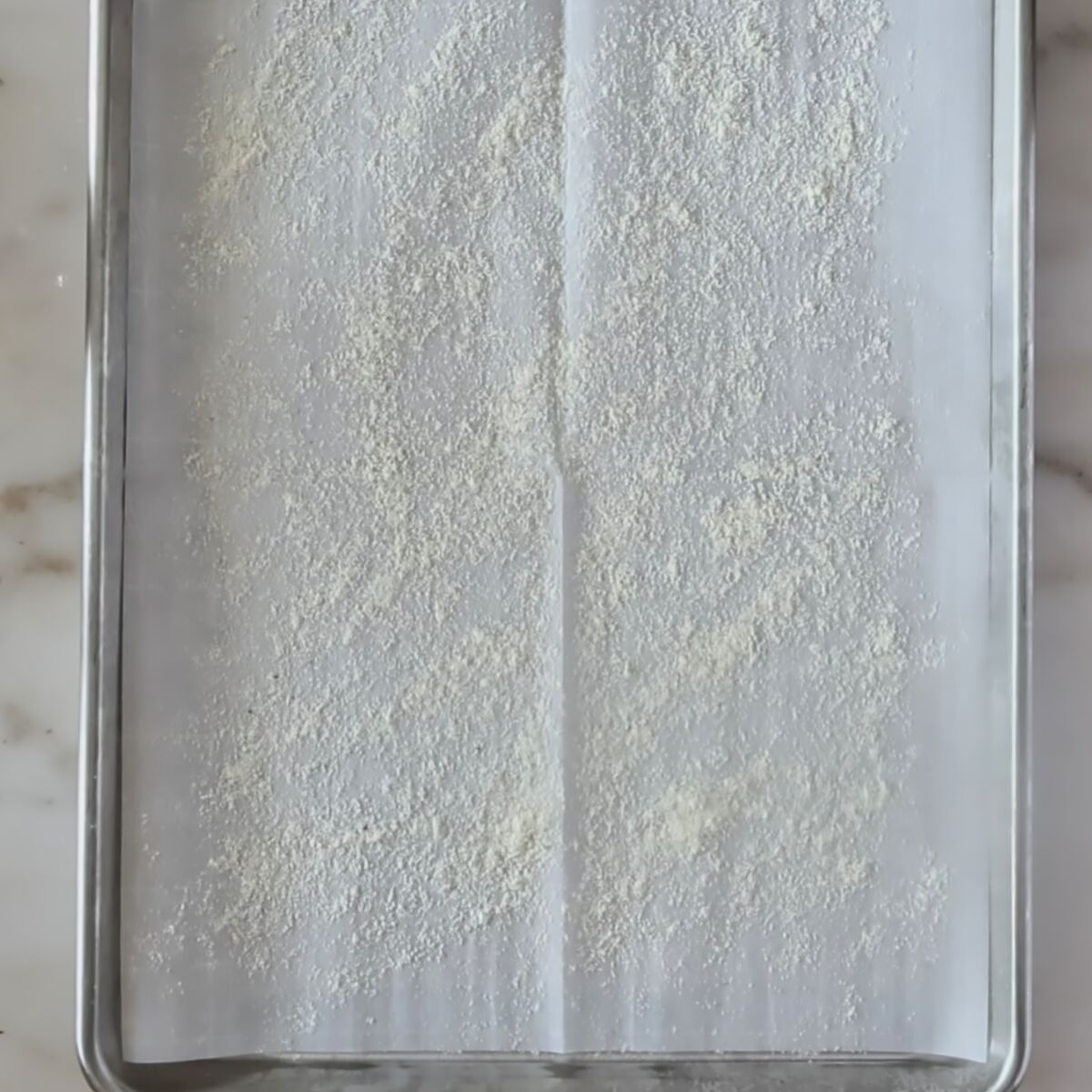 parchment-lined sheet pan sprinkled with cornmeal.