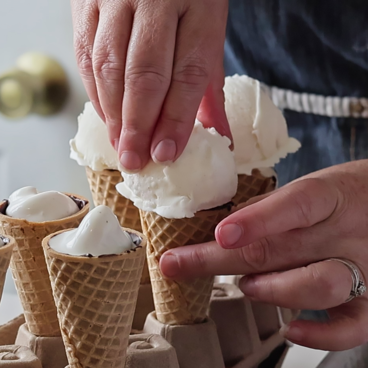 putting frozen ice cream ball on ice cream cone.