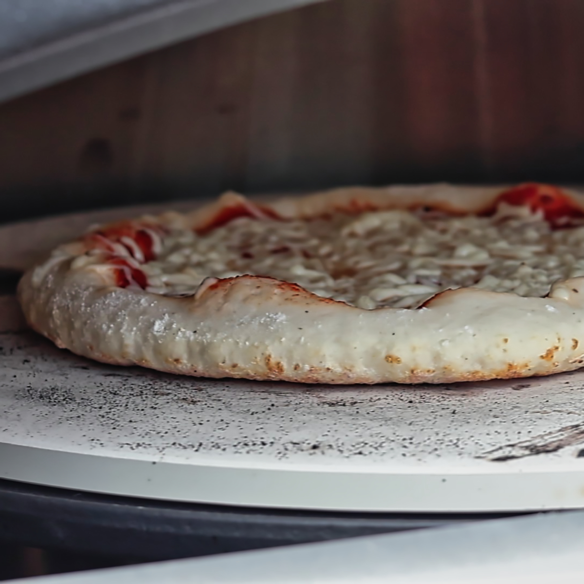pizza puffing up in pizza oven.
