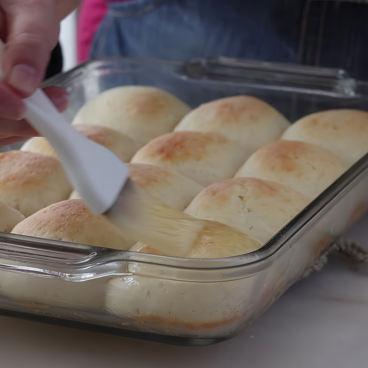 brushing baked rolls with butter.