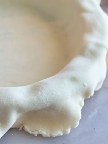 pie crust draped over pie plate.