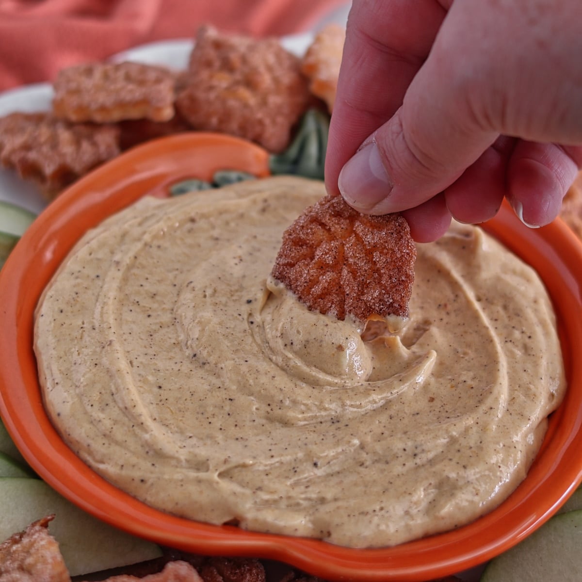 dipping pie crust leaf "chip" into pumpkin dip.