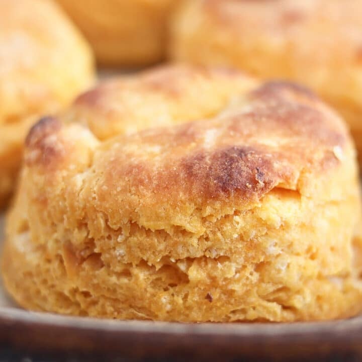 gluten free sweet potato biscuit split open and spread with butter and honey