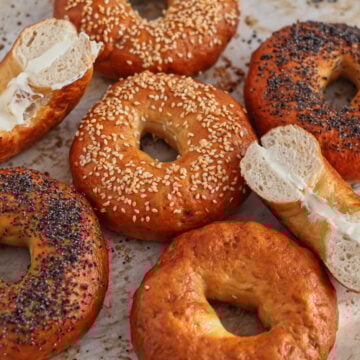different flavored bagels on parchment paper.