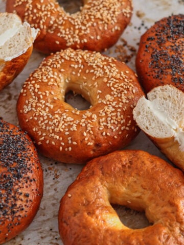 different flavored bagels on parchment paper.